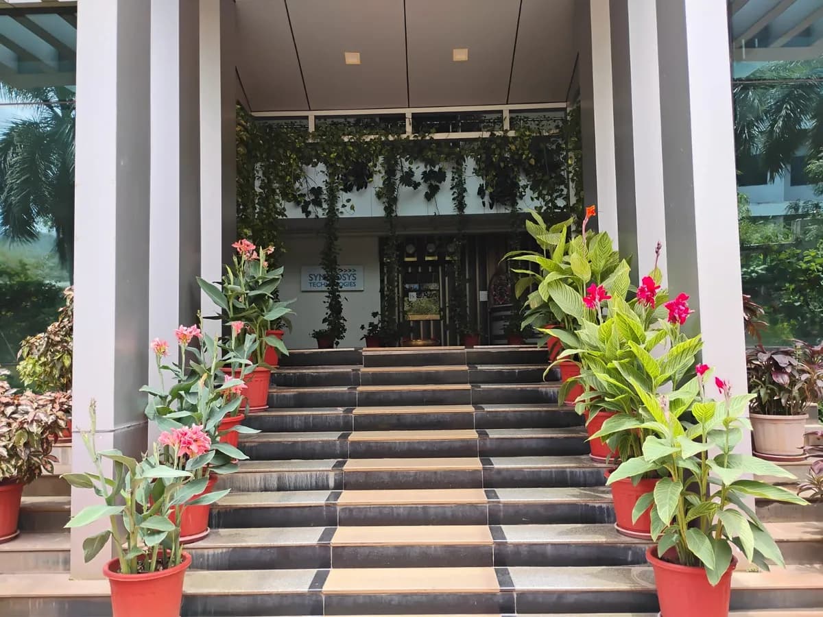 The entrance steps to the Symbiosys Technologies campus, lined with flowering plants