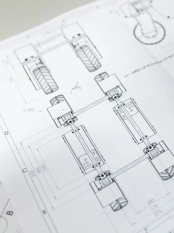 Engineering drawings marked up during a design review