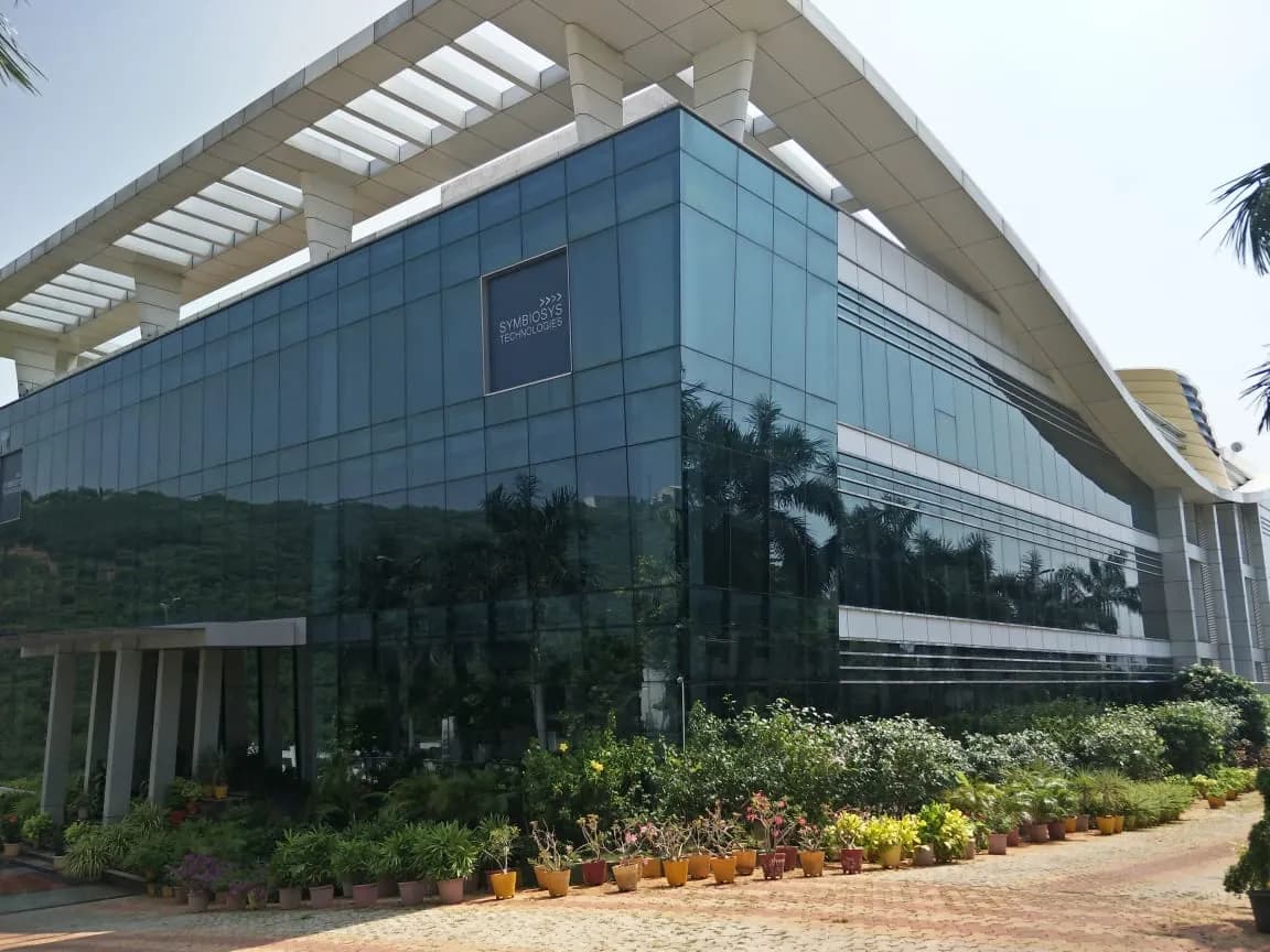 The Symbiosys Technologies campus building with its glass facade and gardens