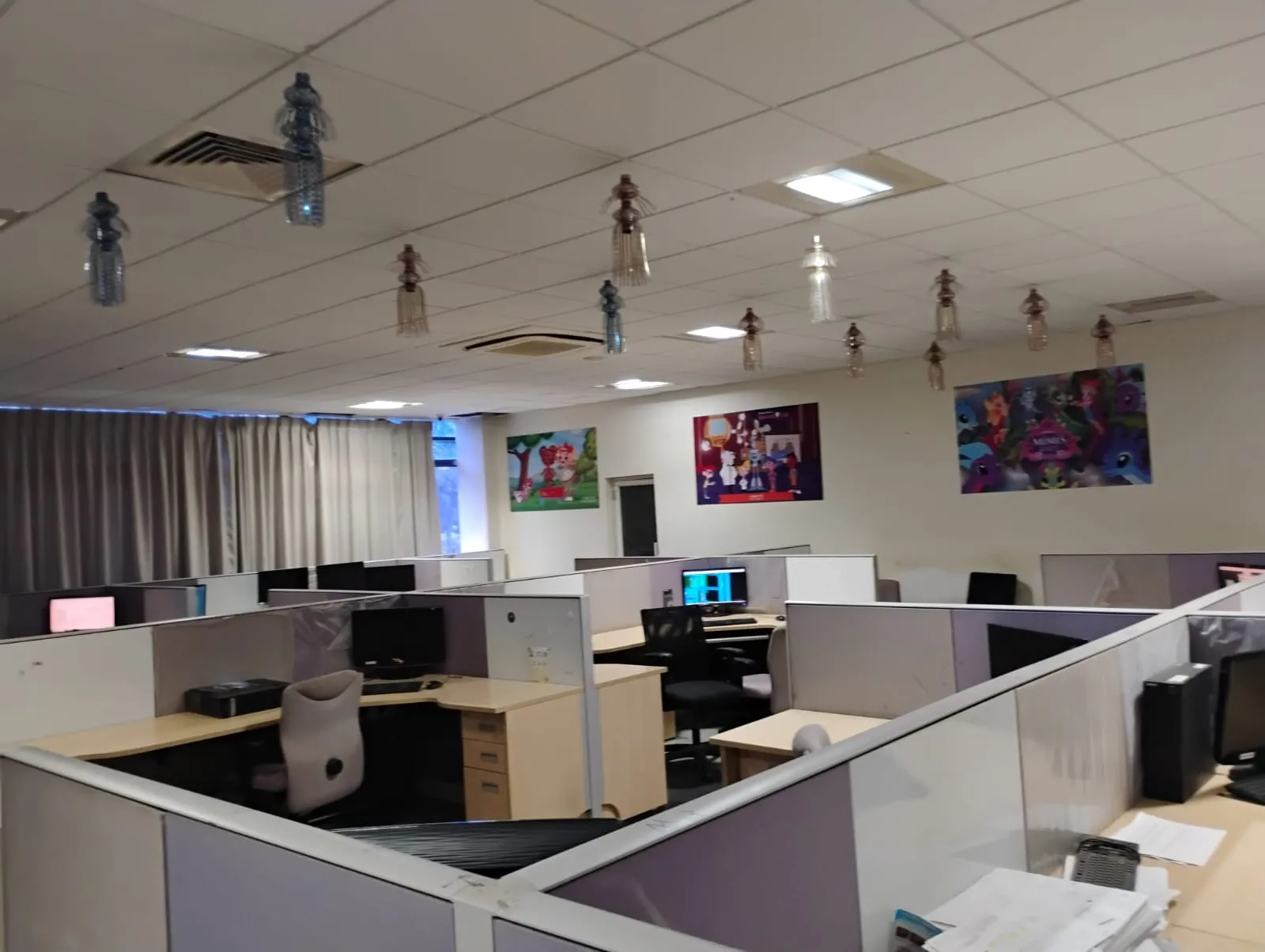 A Symbiosys production floor with artwork from animated series on the walls