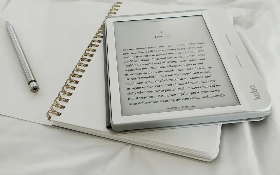 An e-reader resting on a notebook