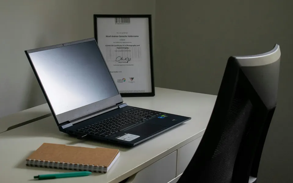 A laptop and notebook on a study desk