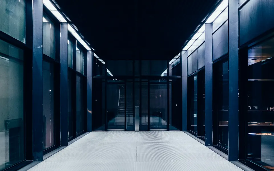 A corridor between rows of server cabinets in a data centre