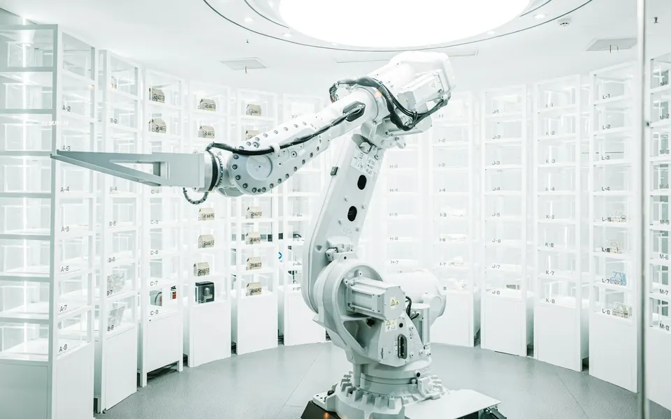 A white robotic arm in an automated facility