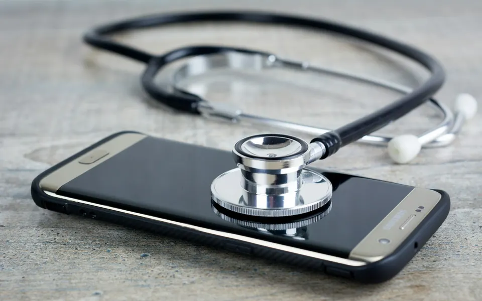 A stethoscope resting on a smartphone