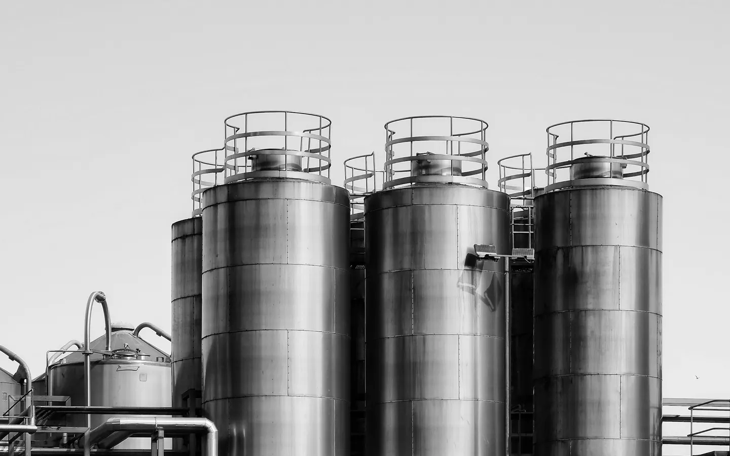 Stainless-steel storage tanks and pipework at a process plant